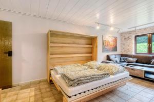 a bedroom with a large bed and a couch at Am Linnert in Haltern
