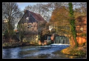 a stream next to a house and a waterfall at Am Linnert in Haltern