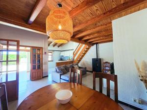 a living room with a wooden ceiling and a dining table at Finca Boy in Pollença