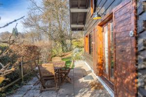 a patio with a table and chairs next to a building at Chalet cosy avec mezzanine in Verchaix