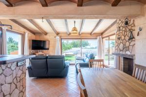a living room with a table and a fireplace at Capricho in Islas Baleares