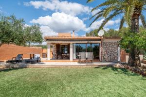 a house with a patio and a yard at Capricho in Islas Baleares