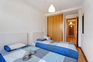 a bedroom with two beds and a hallway at Cozy Tazacorte in Tazacorte