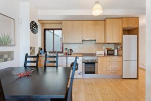 a kitchen with a table and a refrigerator at Cozy Tazacorte in Tazacorte