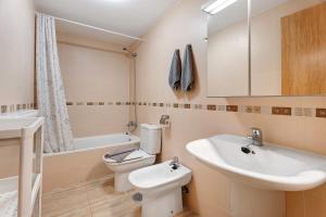 a bathroom with a white sink and a toilet at Cozy Tazacorte in Tazacorte +20 photos