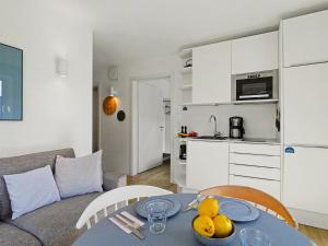 a living room with a table with fruit on it at Apartment Seemomente - 615 by Interhome in Lembruch