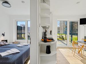 a bedroom with a bed and a dining room at Apartment Seemomente - 615 by Interhome in Lembruch