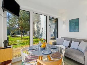 a living room with a table and a couch at Apartment Seemomente - 615 by Interhome in Lembruch