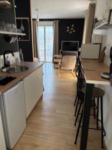a kitchen with a sink and a table with chairs at Studio Sablé sur Sarthe in Sablé-sur-Sarthe +8 photos