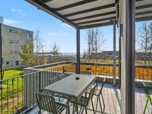 a patio with a table and chairs on a balcony at Apartment Seeflair by Interhome in Lembruch
