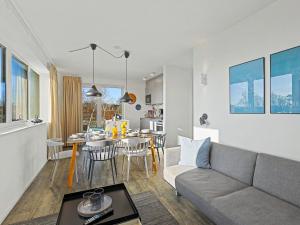 a living room and kitchen with a couch and a table at Apartment Seeflair by Interhome in Lembruch +17 photos