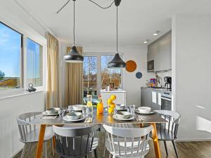 a kitchen and dining room with a table and chairs at Apartment Seeflair by Interhome in Lembruch