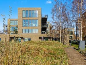 a building on top of a hill with a path at Apartment Seeflair by Interhome in Lembruch