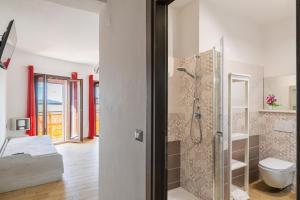 a bathroom with a shower and a toilet at Affittacamere Da Riccardo in Jerzu +38 photos