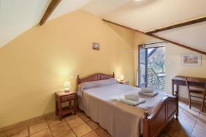 a bedroom with a bed and a large window at La Ferme de la Croix d'Allon in Sarlat-la-Canéda +81 photos