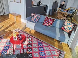 a living room with a blue couch and a red table at Apartment Penthouse Imort - 654 by Interhome in Lembruch