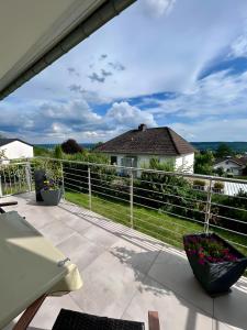 a view from the balcony of a house with a fence at Ferienwohnung In den Haargärten in Möhnesee
