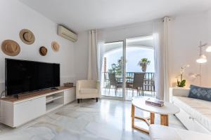 a living room with a tv and a couch at Sea Front Beach House Micaela I in Marbella