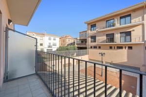 a balcony with a metal gate and a building at Apartamentos de Ángel in Vinebre