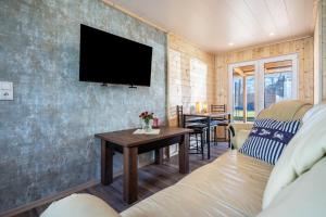 a living room with a tv on a wall at Auszeit Nr 18 in Zempin