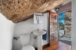 a bathroom with a toilet and a sink at Eco Holidays House Races in Fasnia