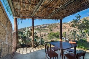 a table and chairs on a patio with a view at Eco Holidays House Races in Fasnia
