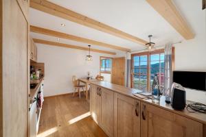 a kitchen with wooden cabinets and a counter top at Ferienwohnung Holzfäller in Lenzkirch