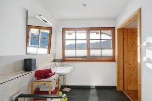 a bathroom with a sink and a mirror at Ferienwohnung Holzfäller in Lenzkirch +17 photos