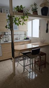 a kitchen with a table with a potted plant on it at Sweetcasitaarinagaplaya in Arinaga