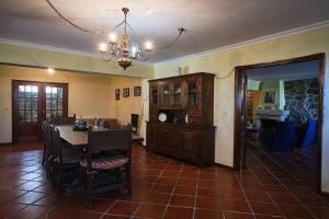 a dining room with a table and a chandelier at Casa do Mogadouro in Mesquitela