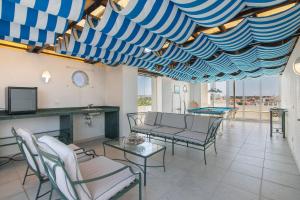 a living room with couches and a table and chairs at Marina Vilamoura Penthouse Luxury in Vilamoura