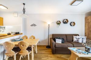 a living room with a couch and a table at Fewo Brünnstein - Nr 27 Pool, Sauna in Oberaudorf