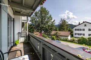 an outdoor balcony with a view of a house at Fewo Brünnstein - Nr 27 Pool, Sauna in Oberaudorf