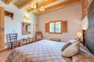 a bedroom with a large bed in a room at Can Bonjesus in Felanitx