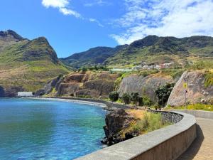 a bridge over a river with mountains in the background at O Marinheiro 15A in Caniçal