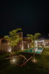a resort with a swimming pool at night at VILA GAHERI Pousada Boutique com Piscina Privativa in São Miguel dos Milagres