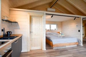 a small bedroom with a bed in a tiny house at Panoramahisli 4 in Fischerbach
