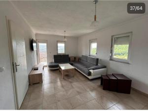 a living room with a couch and a table at Villa Ilijas 3 bedrooms in Ilijaš