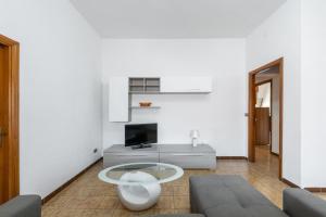 a living room with a couch and a tv at Casa Vacanze Teulada in Teulada