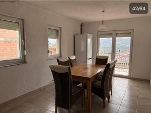 a dining room with a wooden table and chairs at Villa Ilijas 3 bedrooms in Ilijaš