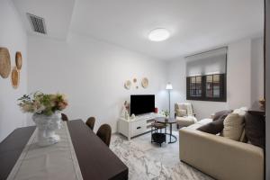 a living room with a couch and a table at Duplex a 9 min De Bajo de Guia in Sanlúcar de Barrameda