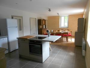 a kitchen with a sink and a stove top oven at Gîte Les Chamois 15 Personnes in Les Rousses