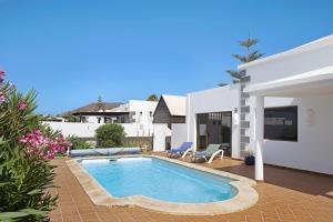 a swimming pool in the backyard of a house at Casa Elian in Lanzarote