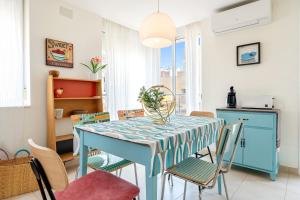 a dining room with a blue table and chairs at Apartamento Sf1 in L'Ametlla de Mar +16 photos