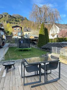a ping pong table and a bench on a deck at Domi Apartment in Gerolstein