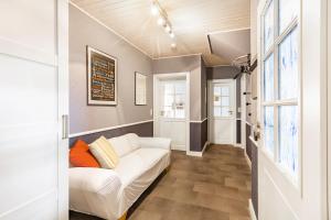 a living room with a white couch and windows at Ferienwohnung Brune in Schmallenberg