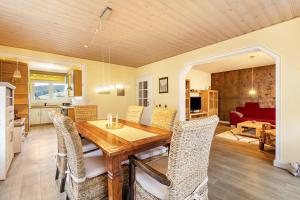 a kitchen and dining room with a wooden table and chairs at Ferienwohnung Brune in Schmallenberg
