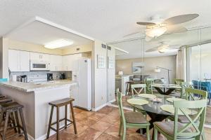 a kitchen and dining room with a table and chairs at Santa Rosa Dunes 923 in Pensacola Beach