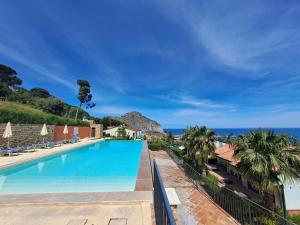 a swimming pool with a view of the ocean at Magarà Apartment by Casa in mente in Cefalù