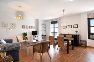 a living room with a table and chairs at Cobijadas75 Janda in Vejer de la Frontera